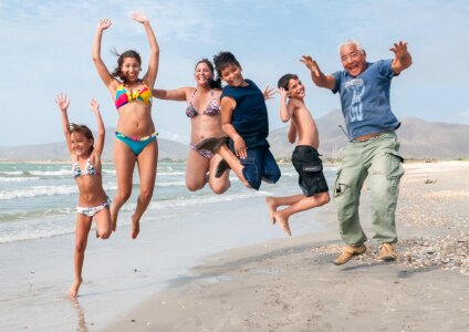 People jumping on the beach photo