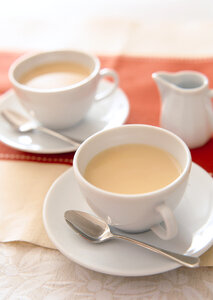 White china cup of tea with milk photo