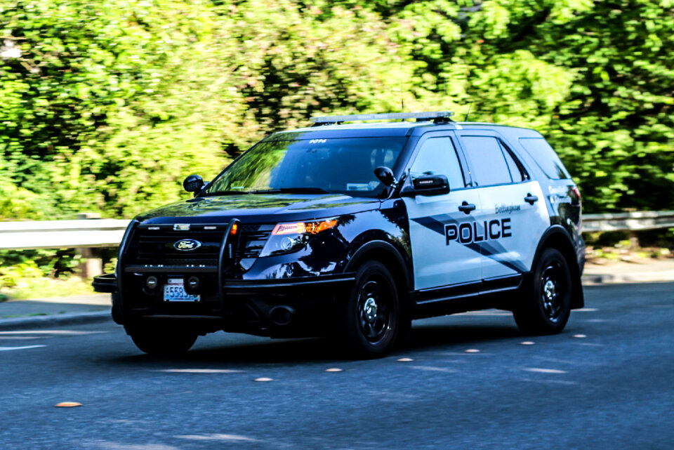 Police car with emergency lights and siren on street