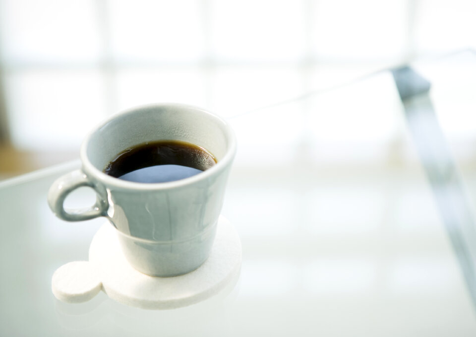 Cup of fresh coffee on table