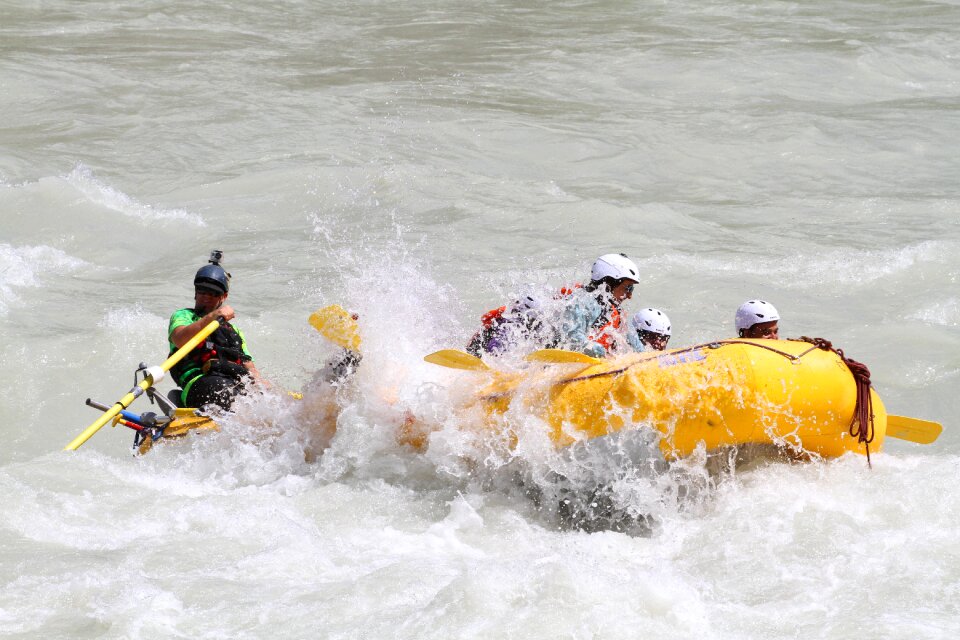 Group of happy people with guide whitewater rafting