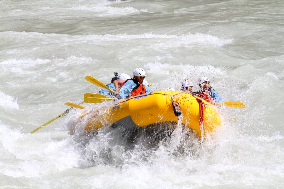Group of happy people with guide whitewater rafting