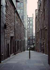 Looking down a long dark back alley photo