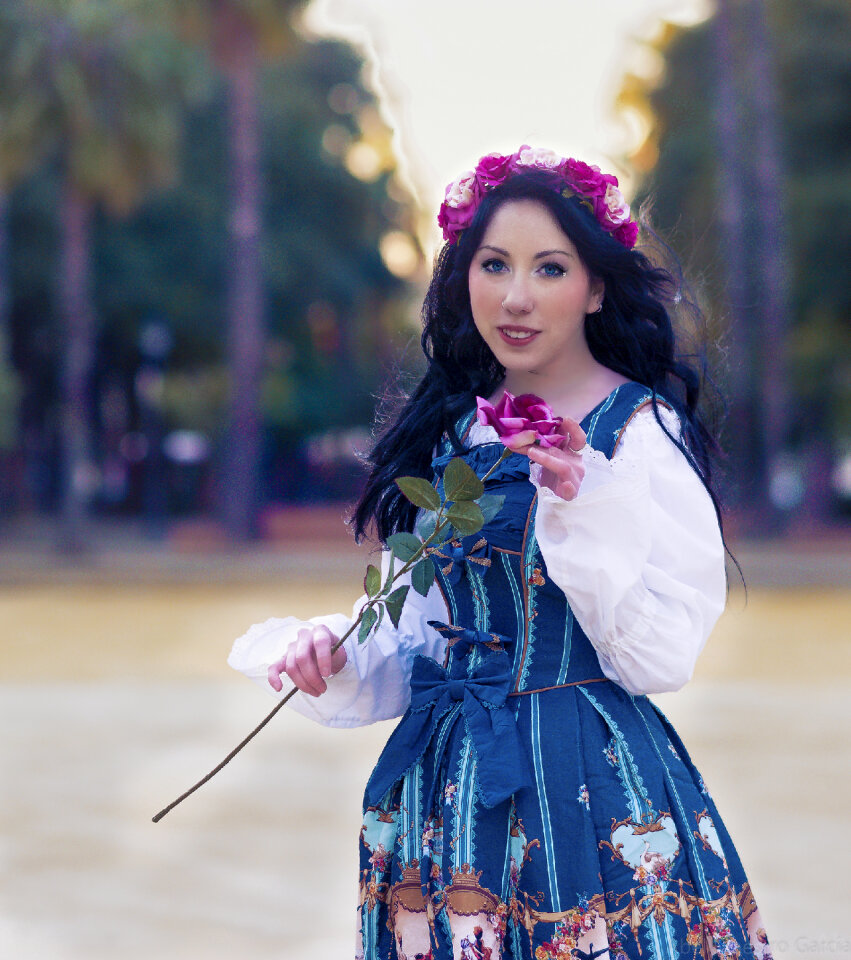 Happy young woman holding flower