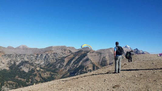 Paraglider sailing above Jackson Hole, Wyoming with blue sky