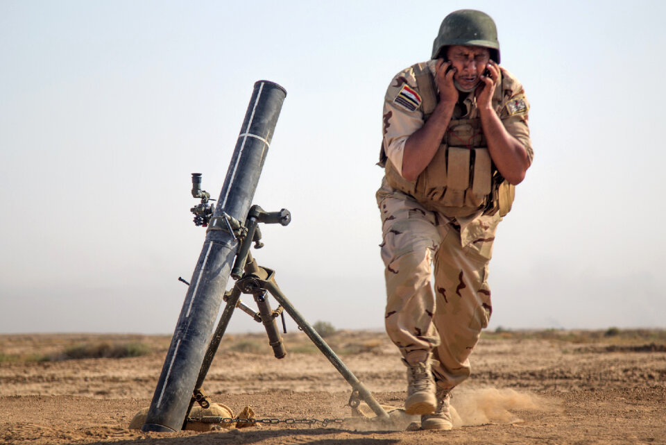 An Iraqi security forces member faces away