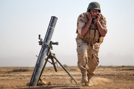 An Iraqi security forces member faces away