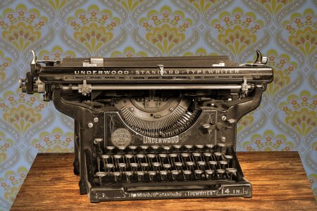 Old Dutch type writer with paper sheet isolated on white photo