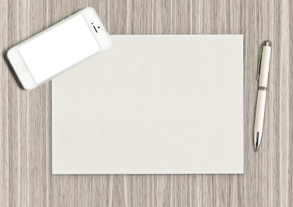 Blank notepad with pen and pencil on office wooden table photo