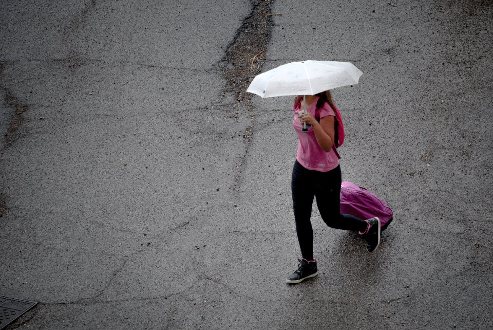 Woman hidden under umbrella
