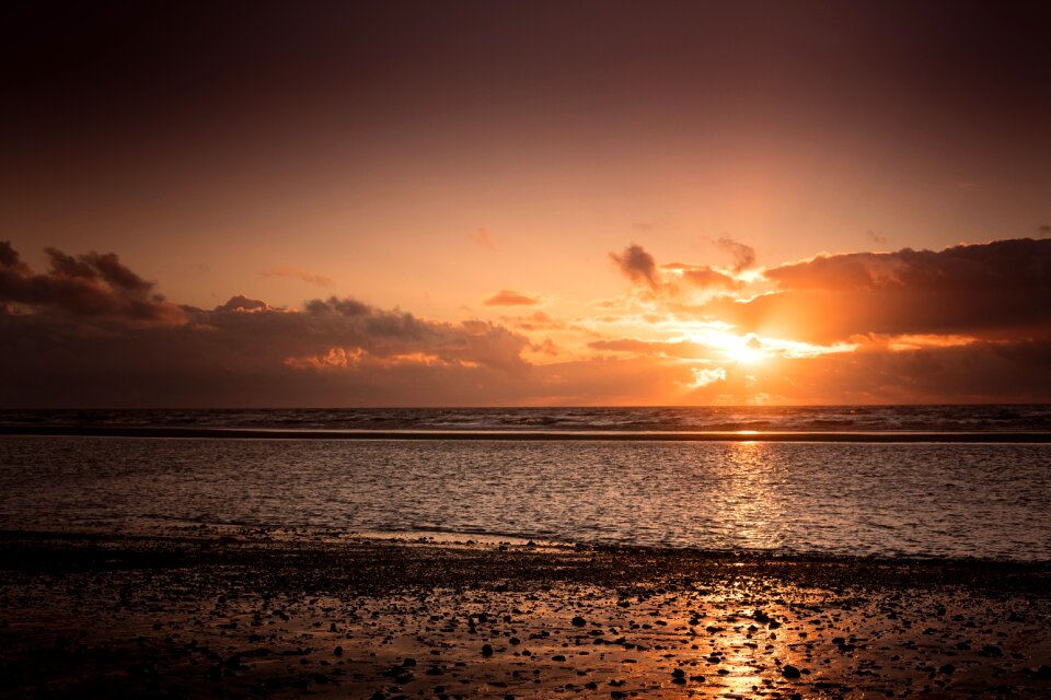 Dark clouds with sun rays over sea