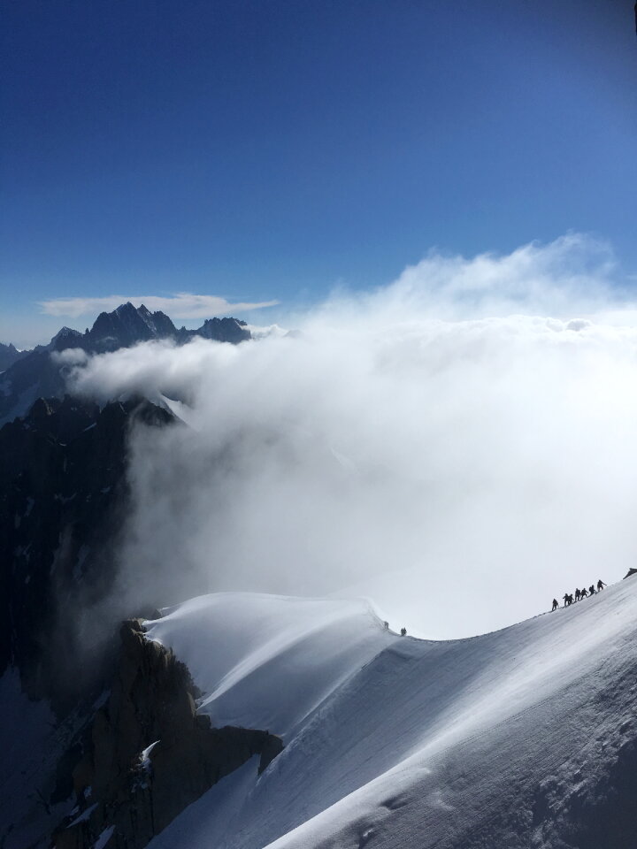 Mont Blanc mountaneers walking on snowy ridge
