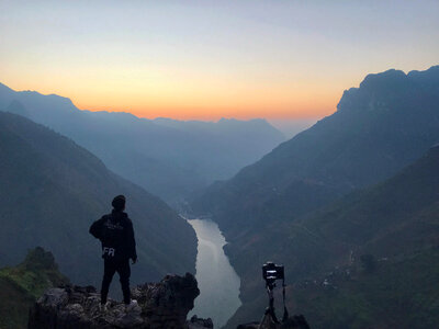 Professional photographer takes photos with camera on tripod