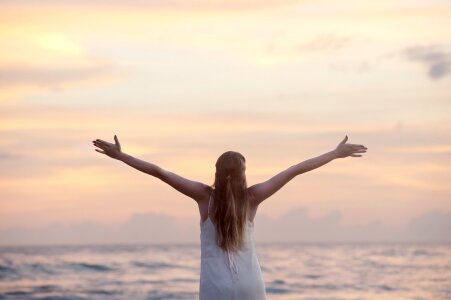 Woman With Arms Raised at Beach photo