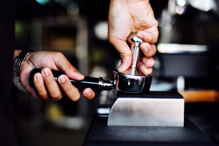 Close-up of espresso pouring from coffee machine photo
