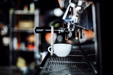 Close-up of espresso pouring from coffee machine photo