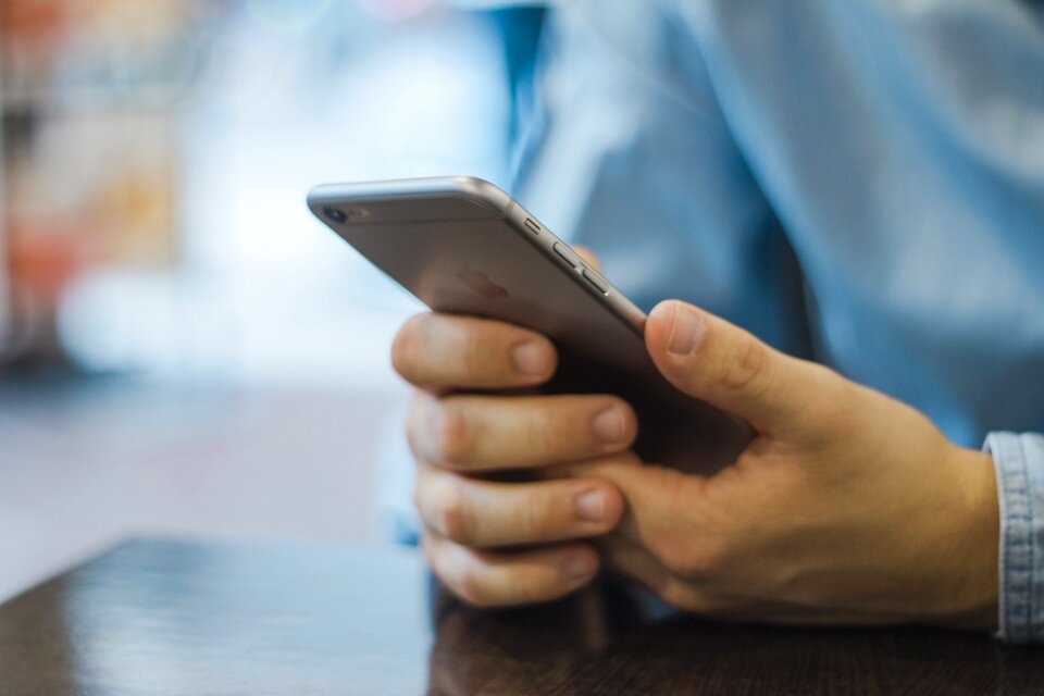 Close up of women's hands holding cell Phone photo