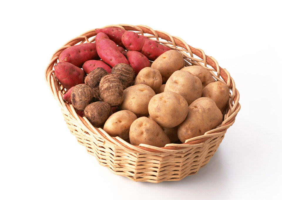 A variety of raw potatoes sweet potato and taro in basket