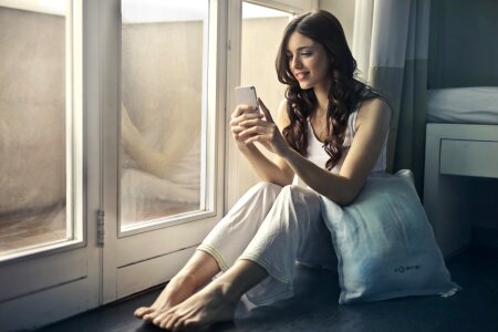 Beautiful young woman using smart phone photo