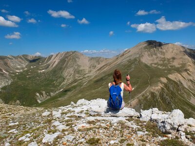 young woman hiker hiking in beautiful mountains