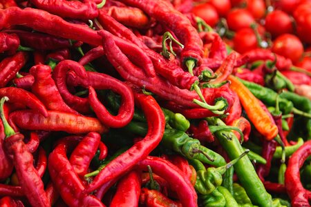 Close up of red and green hot peppers in a pile photo