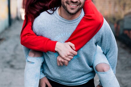 Close up of a woman piggy backing on her boyfriend photo