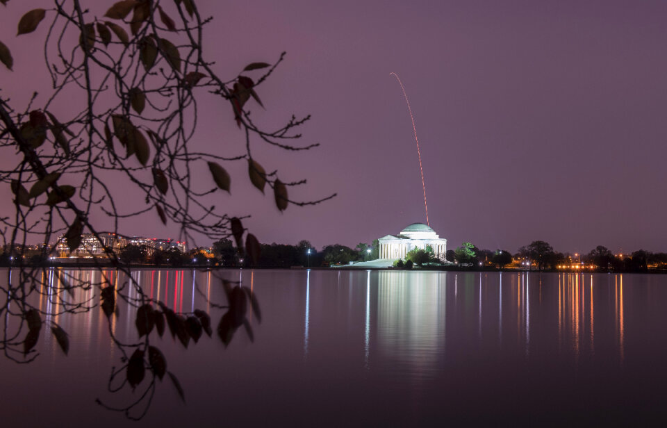 Antares rocket is seen above the Thomas Jefferson Memorial