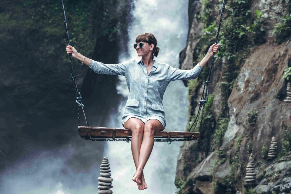 Woman swinging in the jungle of Bali island