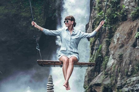 Woman swinging in the jungle of Bali island photo