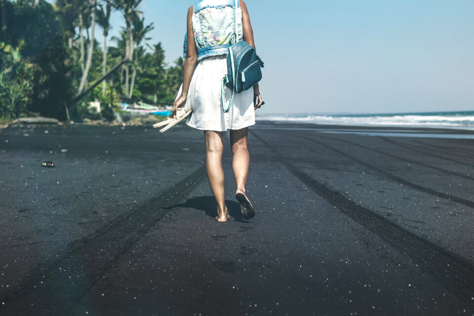 Young woman on a black sand beach