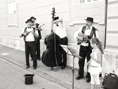 Four local musicians play on the street busking photo