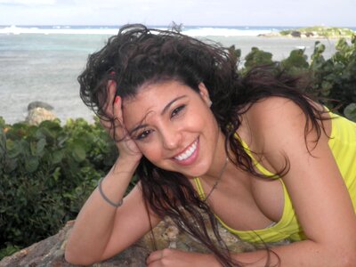 Young Latin woman in front of the sea photo