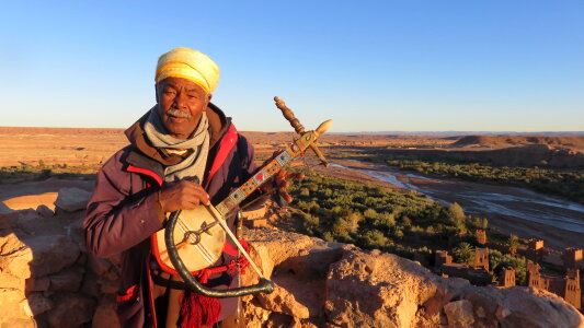 Local Bedouin carrying traditional musical instrument photo