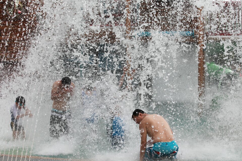 people playing in a water fountain