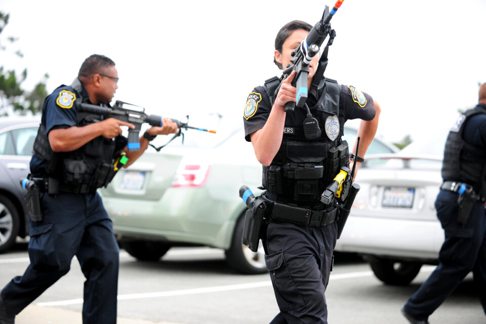 Police in riot gear watches over demonstrators
