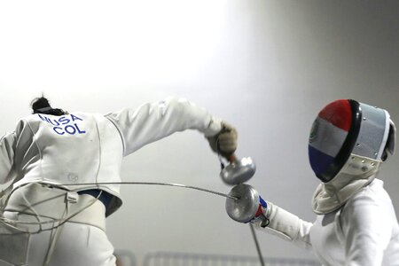 Two Woman fencing athletes fight on professional sports photo
