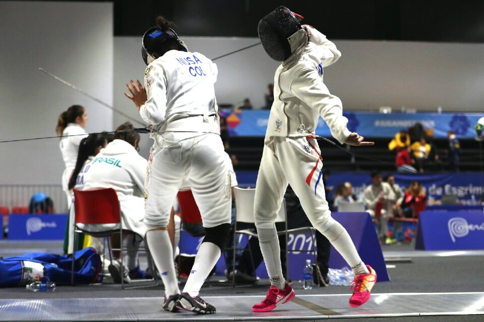 Two Woman fencing athletes fight on professional sports