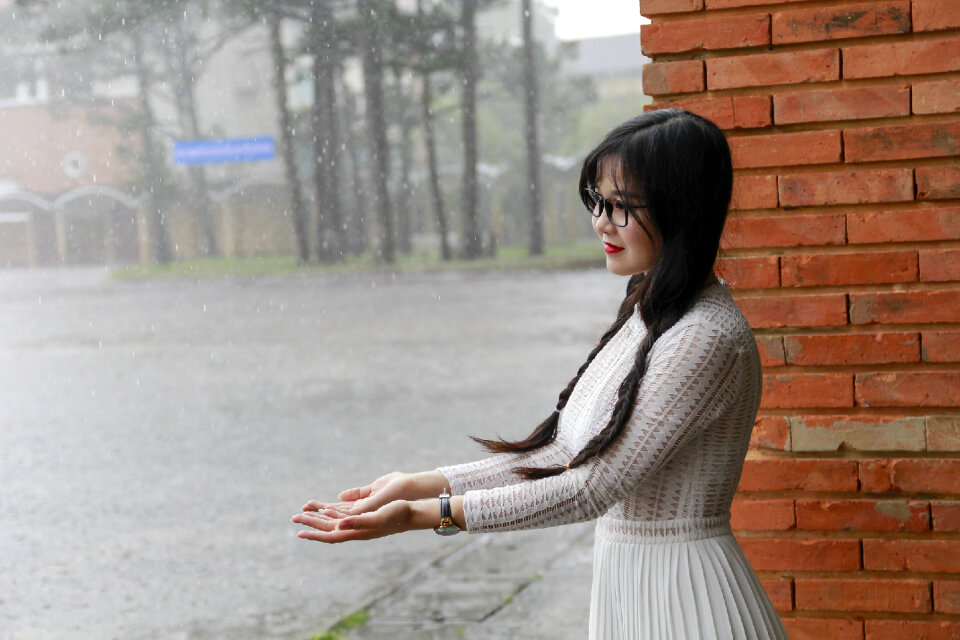 Japanese Woman standing under the rain