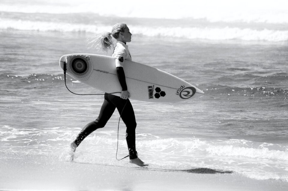 Attractive female surfer with surfboard