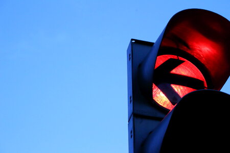 Red traffic light in the city street photo