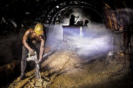 Silhouette of workers in mine photo