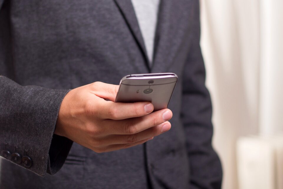 Close up of man's hands holding cell Phone