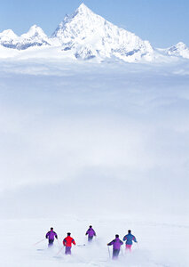 skiers skiing on fresh powder snow