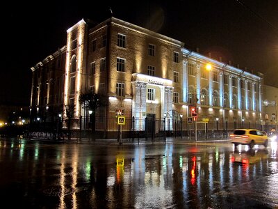 landscape night city streets and lit lanterns after rain