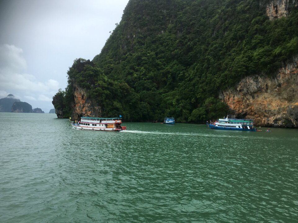 Cave,Tourists kayaking through limestone cliffs in Phang-nga Bay