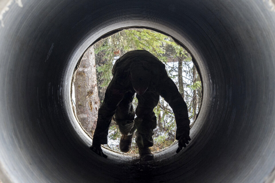 A Soldier with U.S. Army Alaska negotiates a tunnel