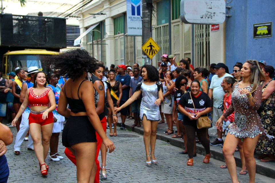 A group of girls in beautiful costumes are dancing at Festival