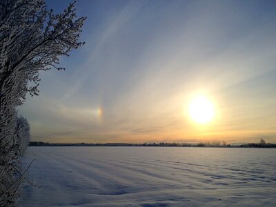 Golden sunset behind snow field