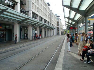 a tram stop with passengers photo