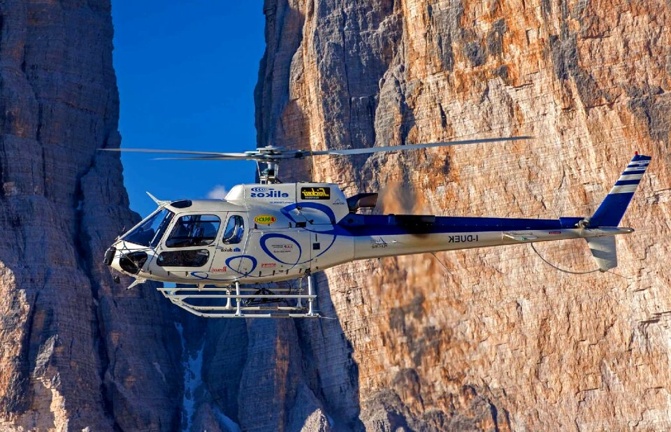 Helicopter flying over snowy mountains